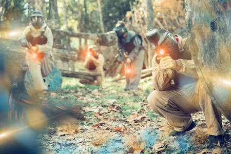 Paintball team aiming outdoorsの写真素材
