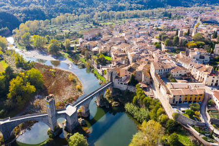 View from drone of Besalu with arched bridge over Fluvia riverの写真素材
