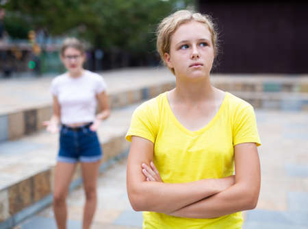 Girl was offended by the girlfriend after quarrel on streetの写真素材