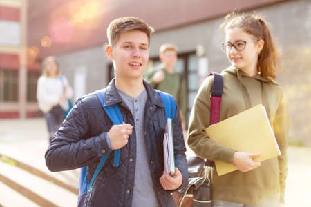 Carefree teen students boy and girl friendly talkingの写真素材