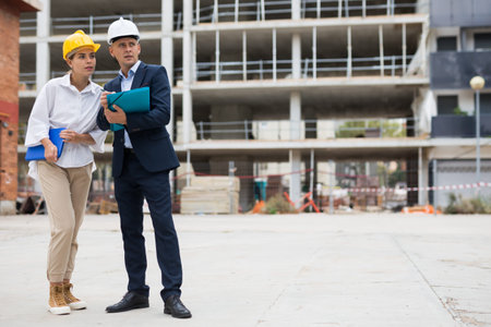 Civil engineers checking work process in construction site