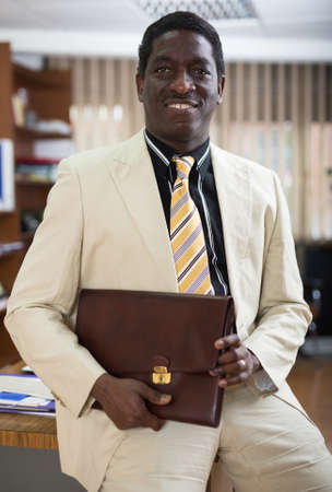 Portrait of friendly businessman in officeの写真素材