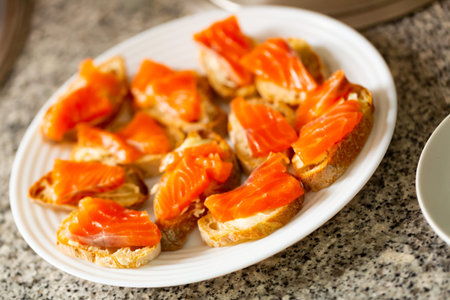 Salmon sandwiches on white plate