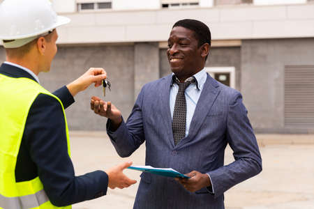 Builder gives the keys to the new home african american businessmanの写真素材