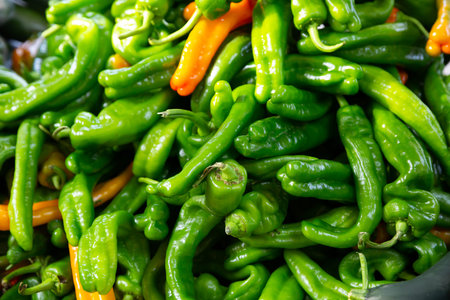 Many bell pepper on counter in grocery store close up