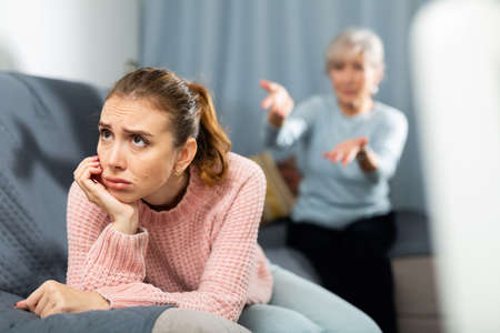 Senior mother encouraging her upset daughterの写真素材