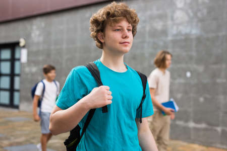 Young boy coming home after school classesの写真素材