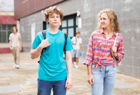 Boy and girl walking home after finishing lessonsの写真素材