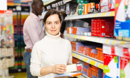 Young woman holding office suppliesの写真素材