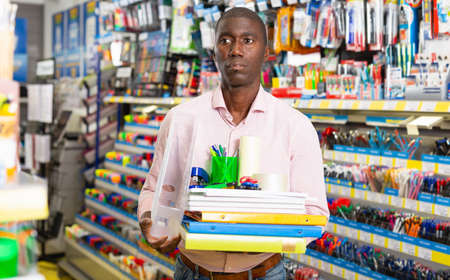 Modern Afro American man holding office suppliesの写真素材