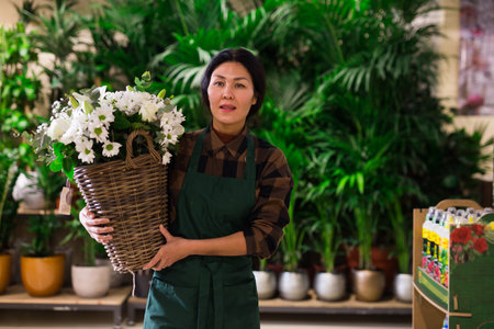 Asian flower seller prepares a luxury bouquet at flower shopの写真素材