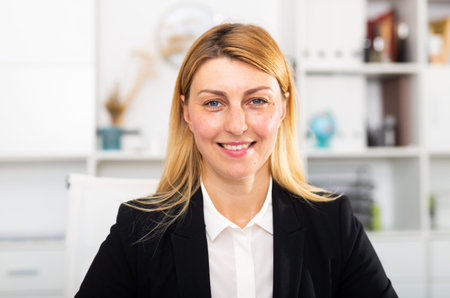 Positive woman manager in office while working day
