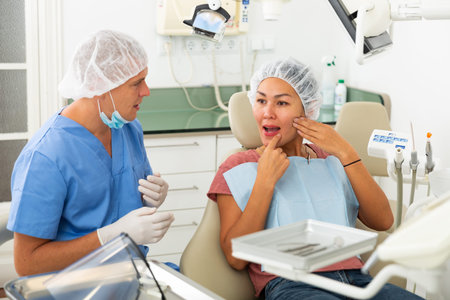 Woman complains of toothache to dentist