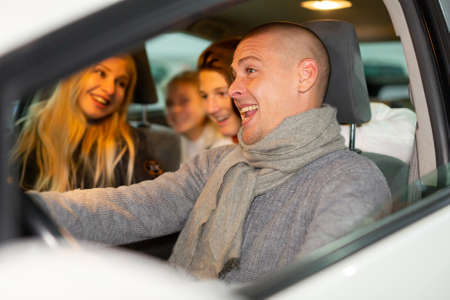 Positive family in carの写真素材