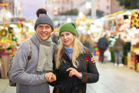 Man and woman at christmas fairの写真素材