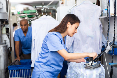 Daily laundry work - woman ironing clothes closeup