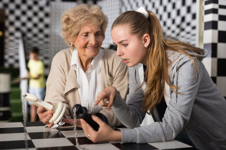Grandmother with tweenager granddaughter trying to find solution of conundrum in lost room designed...