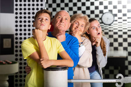 Family of four ponders solution to the puzzle in quest roomの写真素材
