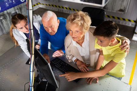 Young girl and boy thinking about riddle solution with their grandparents in escape room.
