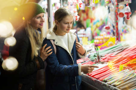 Mother and daughter at sweet shopの写真素材