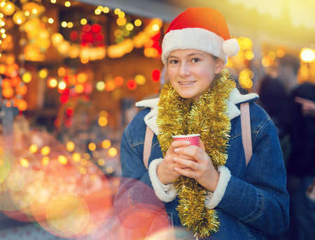 Young girl in santa hat at new years fairの写真素材