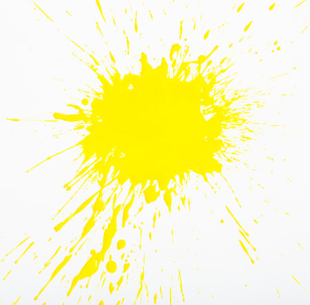 Image of yellow paint spots spilled on background of white paperの写真素材