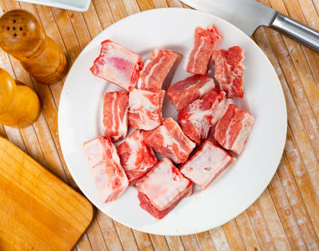 Pieces of uncooked pork ribs on tableの写真素材