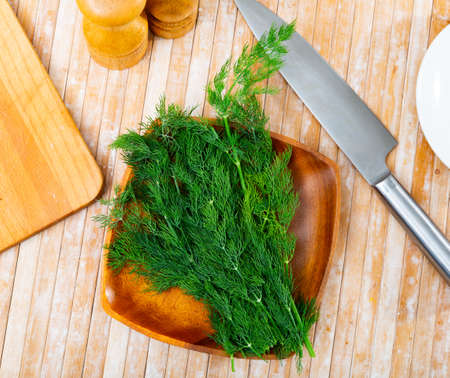 Dill sprigs on kitchen wooden tableの写真素材