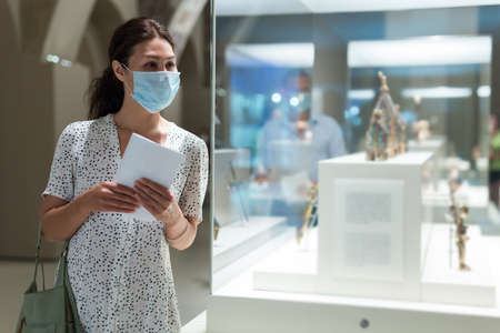 woman admiring art work in museumの写真素材