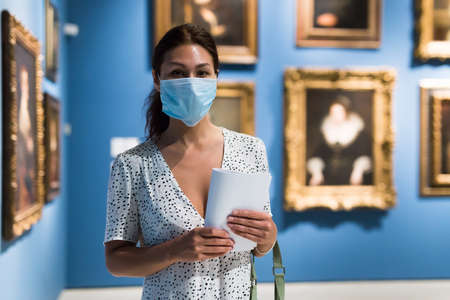 woman admiring art work in museumの写真素材