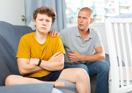 Father comforting his sonの写真素材