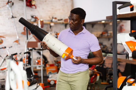Man selecting new air blower in gardening tools shop