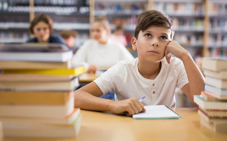 Bored young boy in library