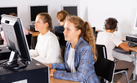 Portrait of a fifteen-year-old schoolgirl studying at a computer