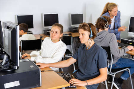 Teenager girls and boys studying in computer labの写真素材
