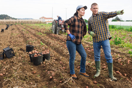 Head of the agricultural holding indicates to hired worker where to work