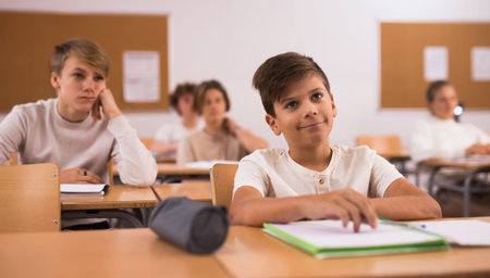 Portrait of teenage schoolgirl sitting on lesson in classroomの写真素材