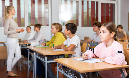 Young boys and girls studying in classroom
