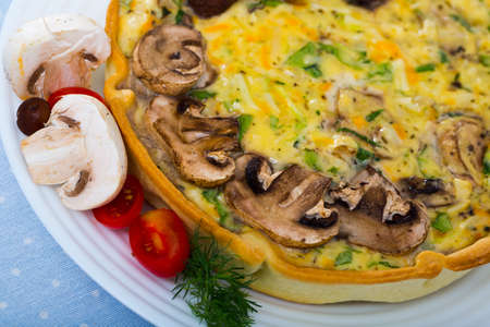 Delicious french kish cooked with cheese and mushroomsの写真素材