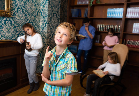 Boy are thinking about solving a problem in quest room