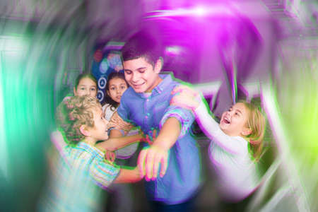 Tween children trying to solve riddles in quest room, toned imageの写真素材