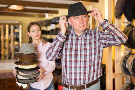 Man trying on hat in shopの写真素材