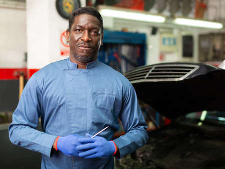 Portrait of african male mechanician posing in workshopの写真素材