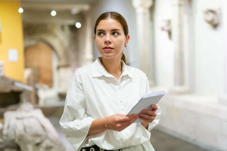 Woman visiting sculpture hall in historical museumの写真素材