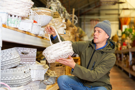 Man choosing decorative wicker basketの写真素材