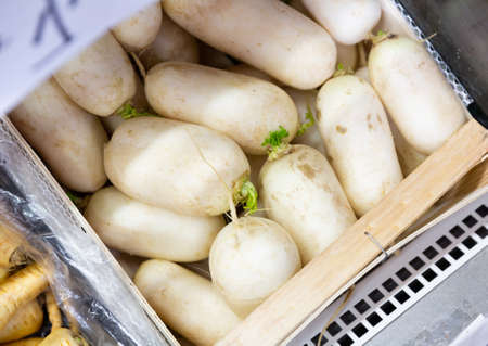 Fresh organic radishes in boxes at marketの写真素材
