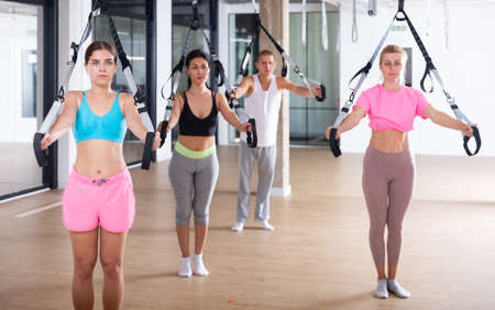 People training trx pilates at group classの写真素材