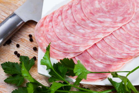 Catalan sausage slices on wooden backgroundの写真素材