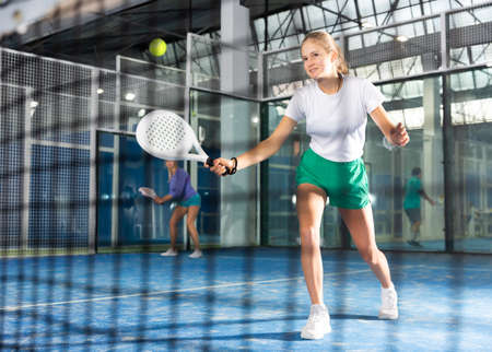 Girl tennis player playing padel tennisの写真素材