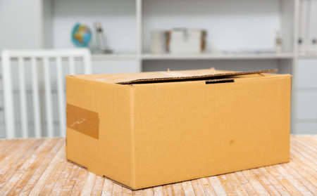 One cardboard box on top of tableの写真素材